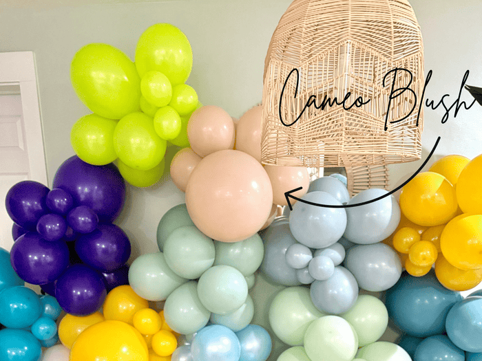 Balloon party display with peach cameo blush balloons among pastel colors