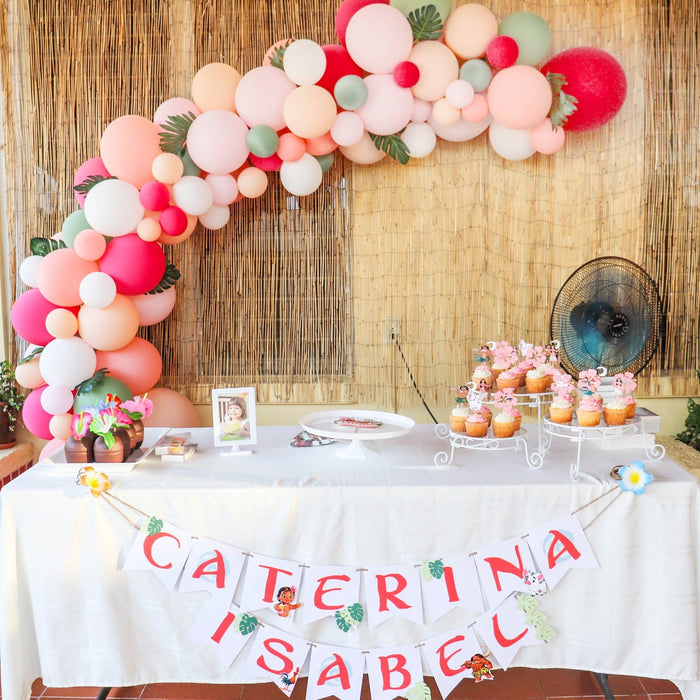 Pastel balloon garland centerpiece with coral, blush, and cream latex balloons over table decor