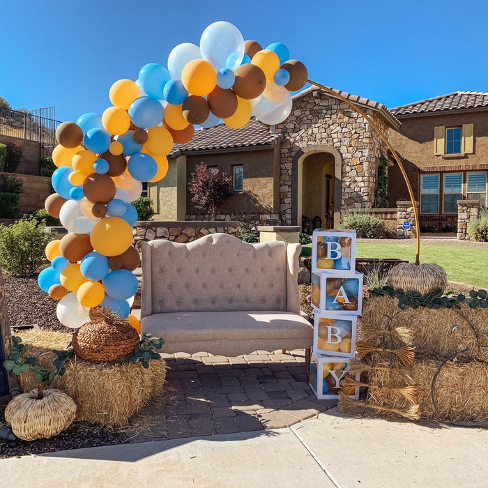 Balloon arch with gold, white, and blue latex balloons