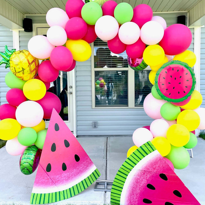 Balloon arch with watermelon decorations and mixed pink and lime green latex balloons