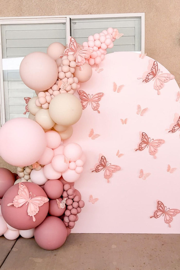 Pastel pink latex balloon cluster with butterfly accents