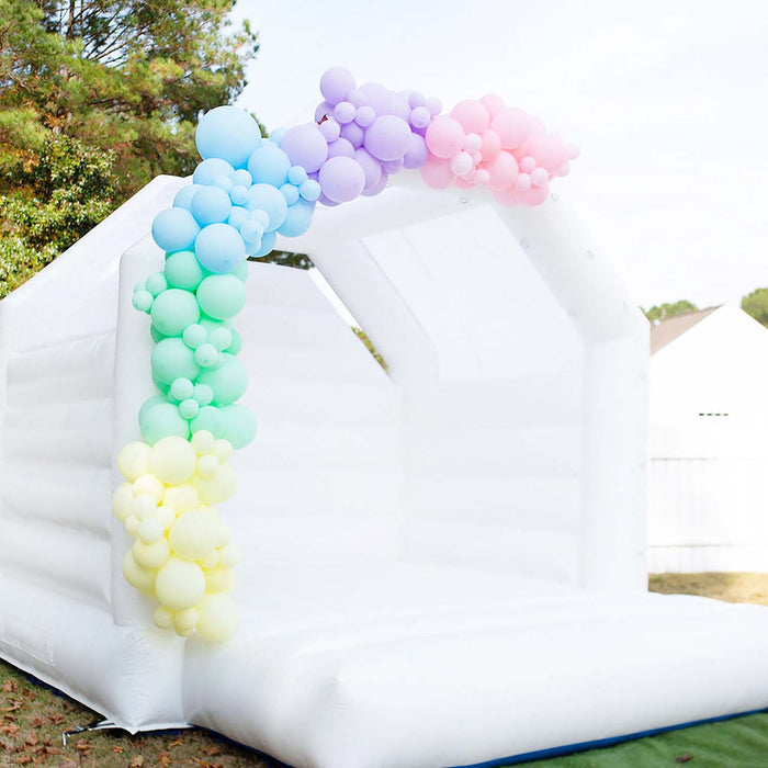 Pastel latex balloon arch with blue, green, and yellow balloon clusters