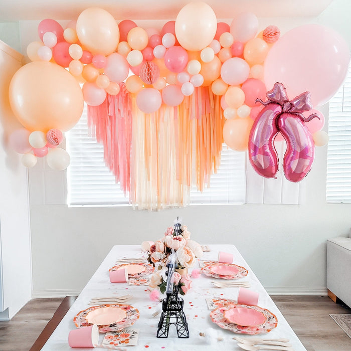 Pink balloon cluster garland with pale peach balloons and a foil unicorn balloon