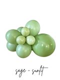 Sage green latex balloon cluster with five balloon sizes, glossy finish, tied centerpiece