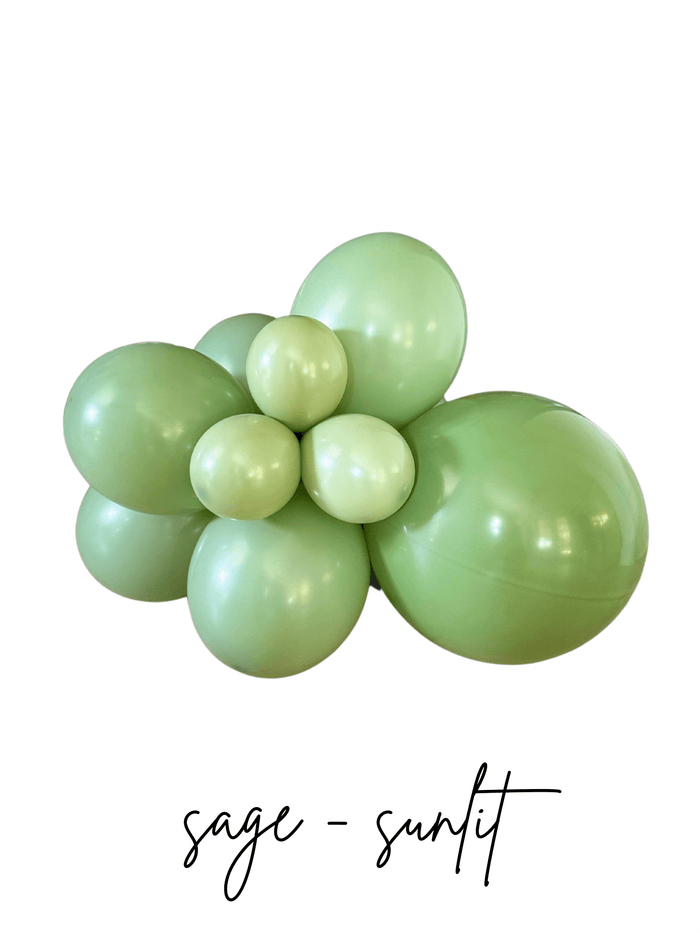 Sage green latex balloon cluster with five balloon sizes, glossy finish, tied centerpiece