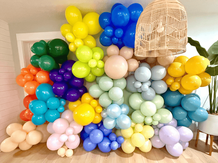 Large multi-color latex balloon backdrop with tightly packed glossy balloons