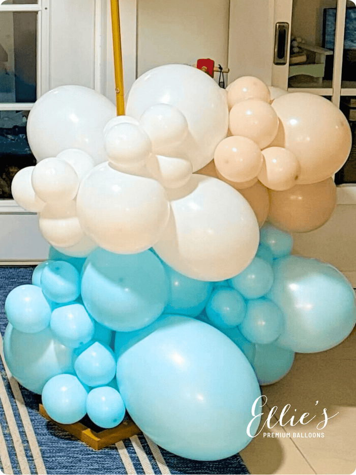 Multicolor balloon cluster with white and blue balloons, peach accents