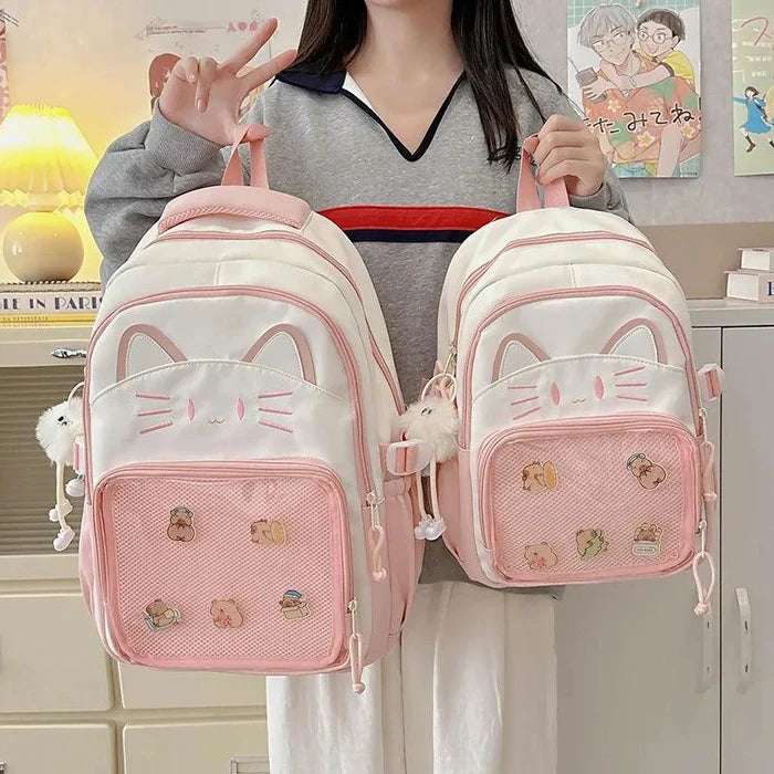 Pink ita-style school backpack with cat-face front pocket and mesh panel