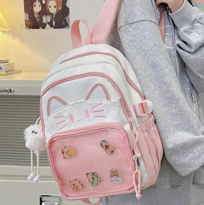 Pink ita-style school backpack close-up with cat-face flap and front mesh pocket