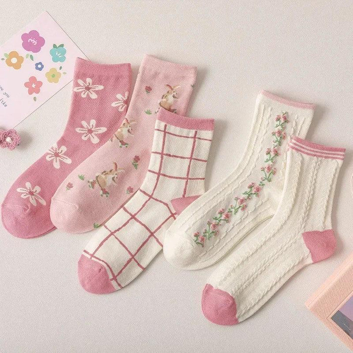 Set of pink and white floral socks with flower and grid patterns