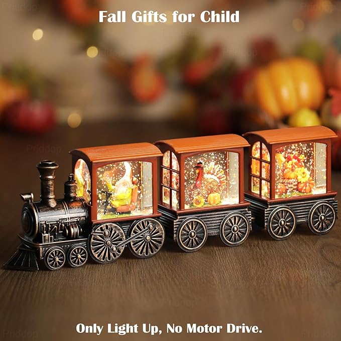 Lit train snow globe with orange cab, black wheels and arched windows with falling glitter effect