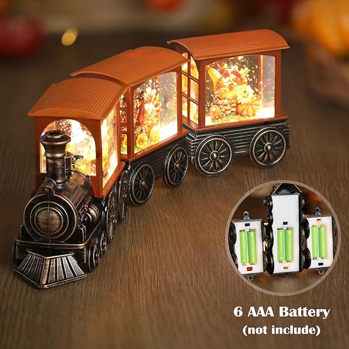 Orange-roof steam train snow globe showing lit side window and speaker-style battery compartment
