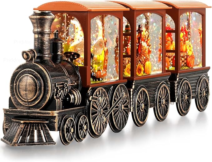 Front three-quarter view of orange-and-black steam train snow globe with lit, glitter-filled windows