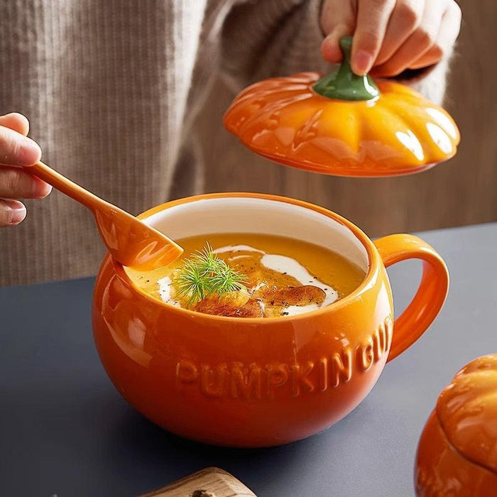 Pumpkin-shaped ceramic mug with lid, orange glaze, green stem, side handle
