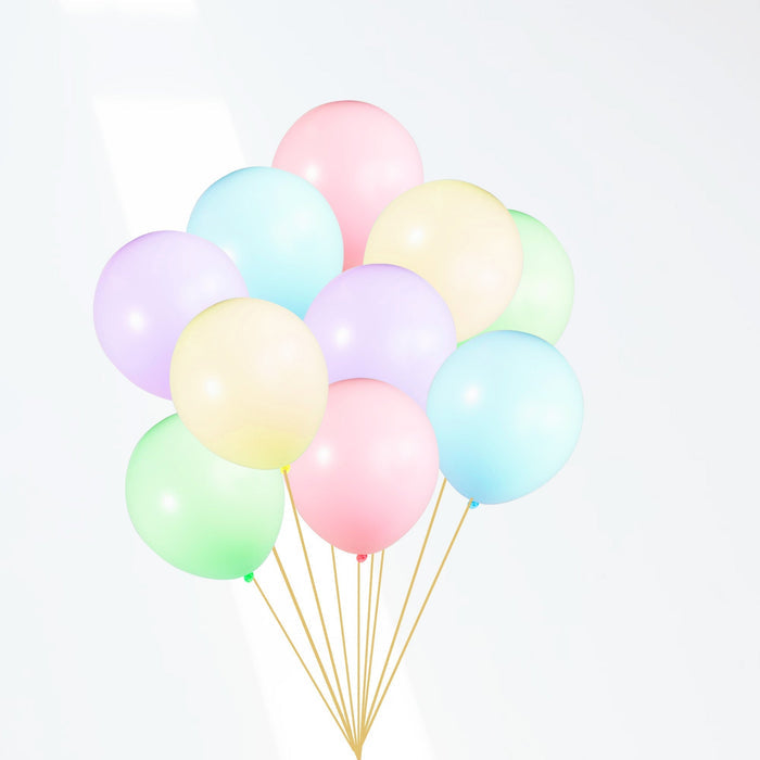 Pastel latex balloon bouquet with pink, blue, green, purple, and yellow balloons and gold strings