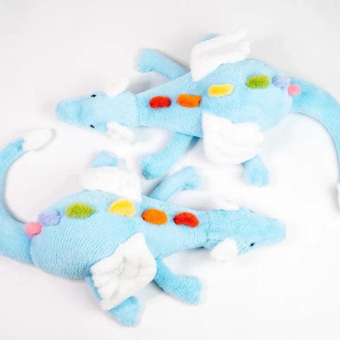 Two light blue plush dragons with white wings and multicolor dot accents, lying together