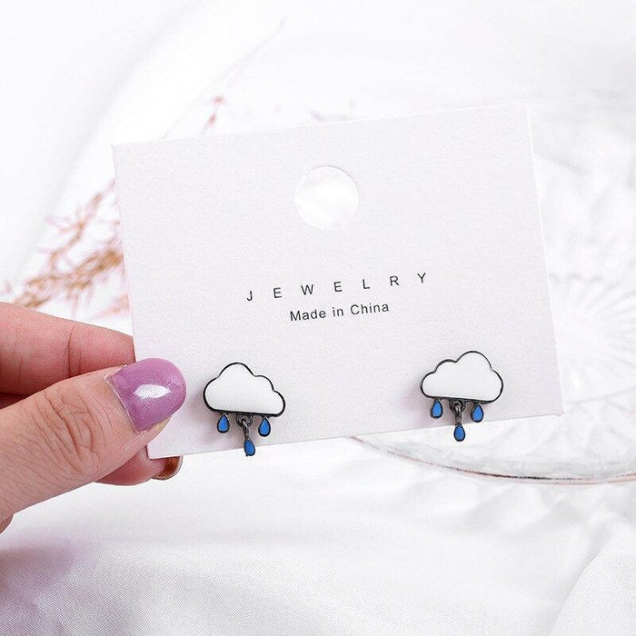 Cloud rain earrings with blue raindrop charms on jewelry card