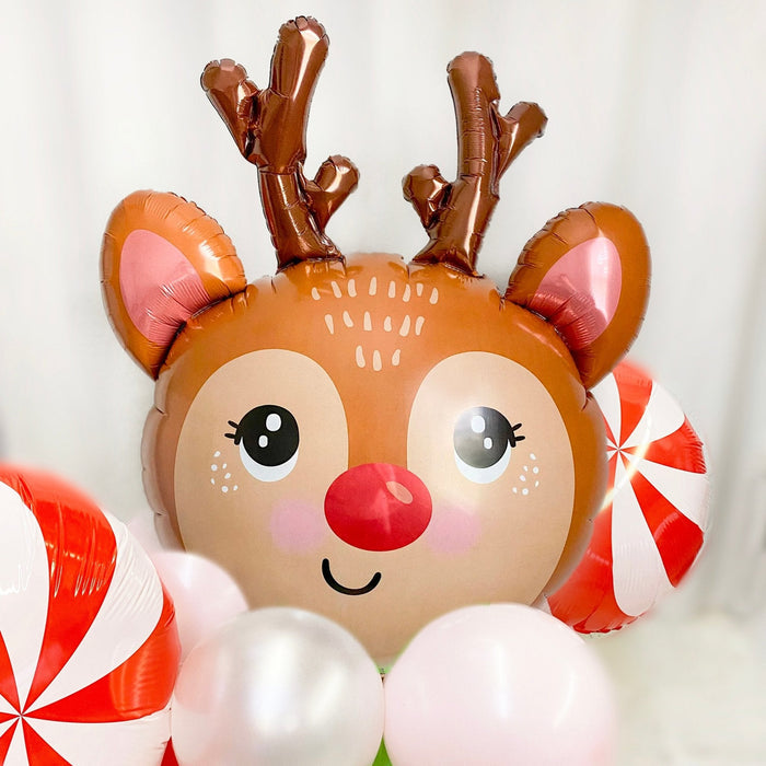 Reindeer balloon head with brown antlers, pink ears, and red-and-white peppermint swirl balloons