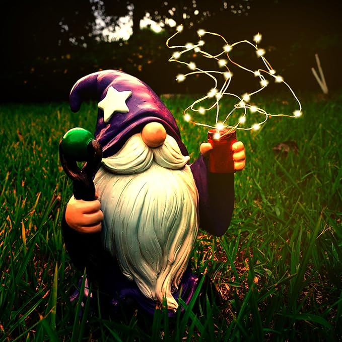 Purple gnome garden statue with glowing solar LED string lights, holding a red lantern