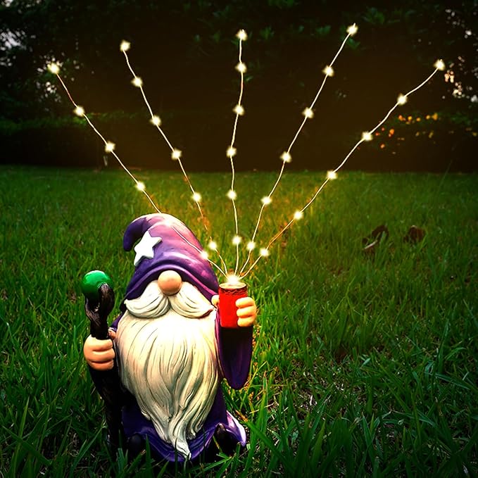 Purple gnome garden statue with glowing solar LED string lights, kneeling on grass
