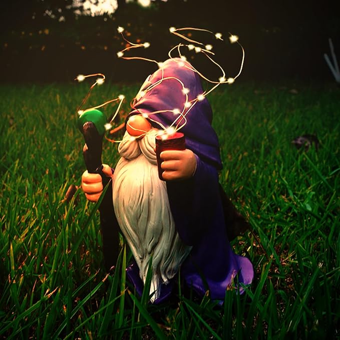 Purple gnome garden statue with glowing solar LED string lights, holding a red firework light