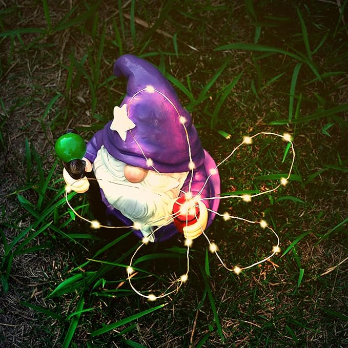 Purple gnome garden ornament with glowing solar LED string lights across the body
