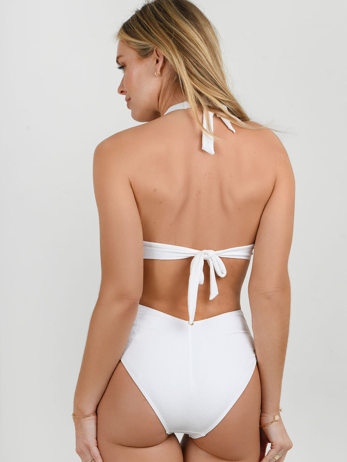Model wearing the Rio Cut out swimsuit in white marble by NAIA Beach