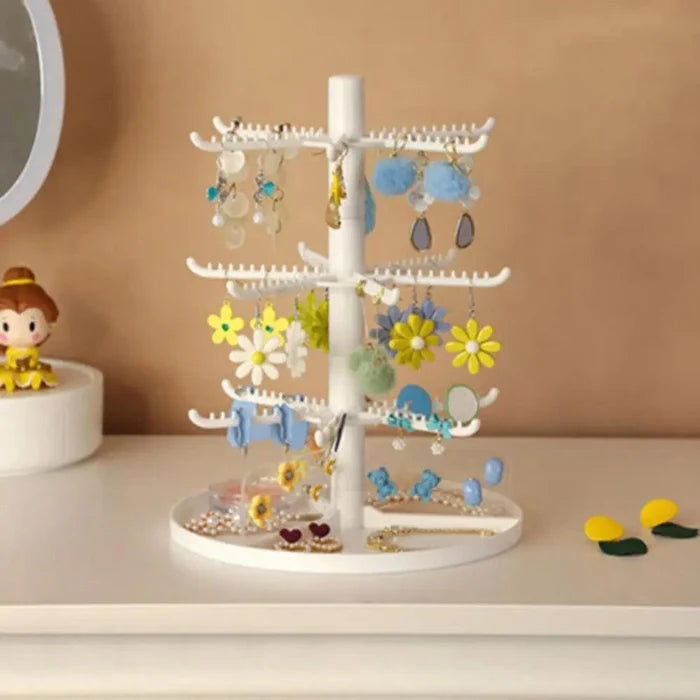 White rotating earring stand on round base with flower and dangling earring pieces