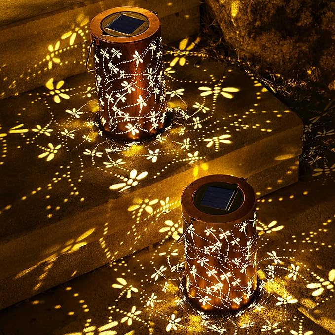 Brown solar lanterns with white dragonfly and flower patterns, warm light on ground