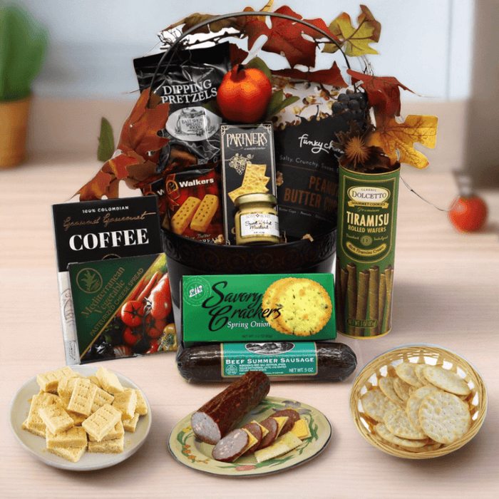 Gift basket with fall-themed shredded filler and wrapped snacks, pretzels, coffee, chocolate