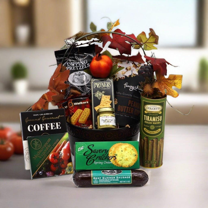 Gift basket with assorted packaged snacks, coffee, and sweets, in a decorative round tub