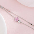 Silver charm bracelet with pink cherry blossom flower and small heart accents