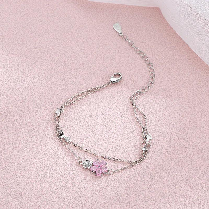 Silver charm bracelet with pink blossom center and lobster clasp