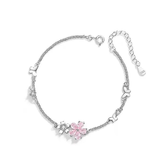 Silver adjustable bracelet with pink cherry blossom charm cluster and heart links