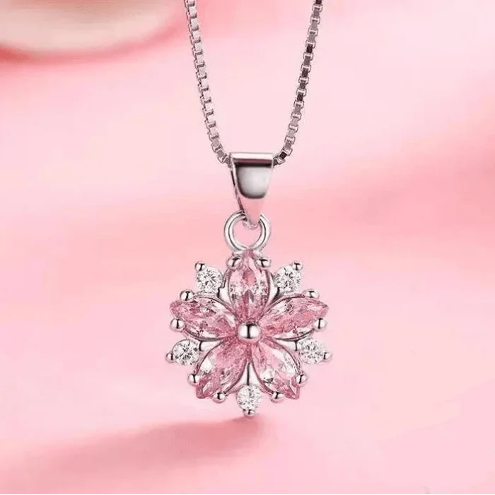 Silver-toned necklace with pink cherry blossom flower pendant and round loop bail