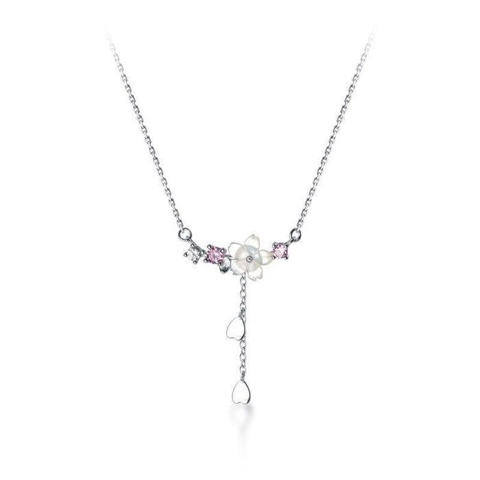 Silver tone pendant necklace with flower charm cluster and dangling teardrop charm