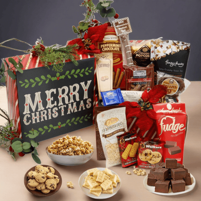 Christmas gift box filled with assorted chocolates and sweets, open with red bow decor