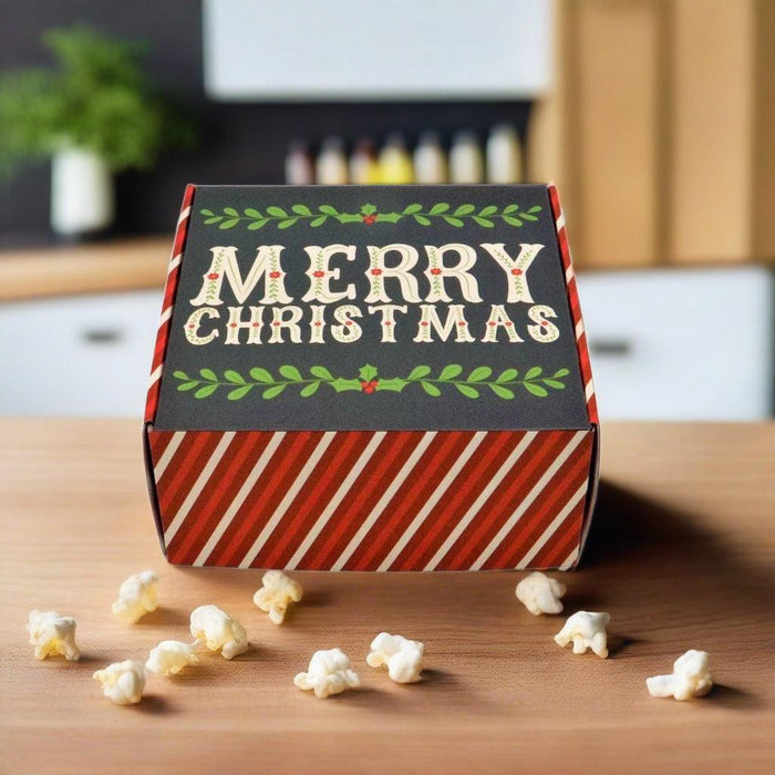Christmas gift box, closed, red stripes with MERRY CHRISTMAS text on front