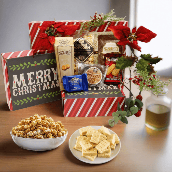 Festive gift box filled with assorted chocolates and candy, topped with red bows