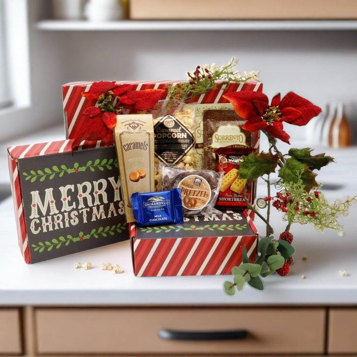 Festive gift box with assorted candy packs and chocolates, secured with red bow