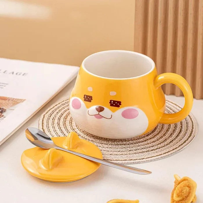 Yellow dog-face mug with handle, stainless spoon and lid resting on a coaster