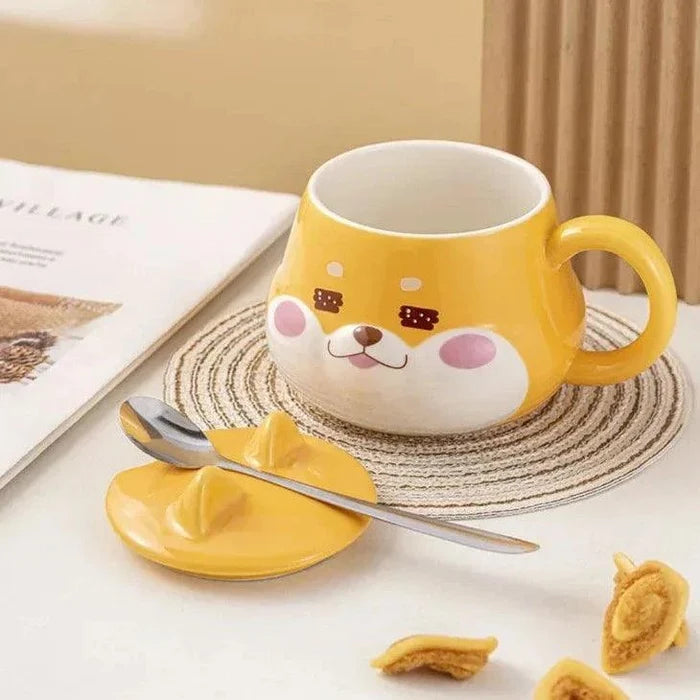 Yellow dog-face mug with lid and handle, spoon on coaster and small snack pieces