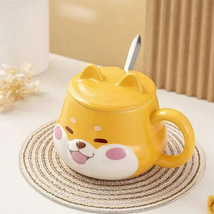 Yellow dog-face mug with lid and side handle, front view on a striped coaster
