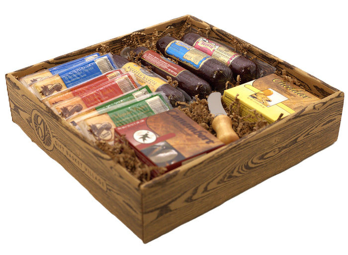 Open wooden gift box with wrapped sausages, cheese wedges, and assorted snack packages