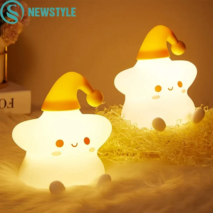 Silicone star LED night light, glowing white body with yellow cap and handle