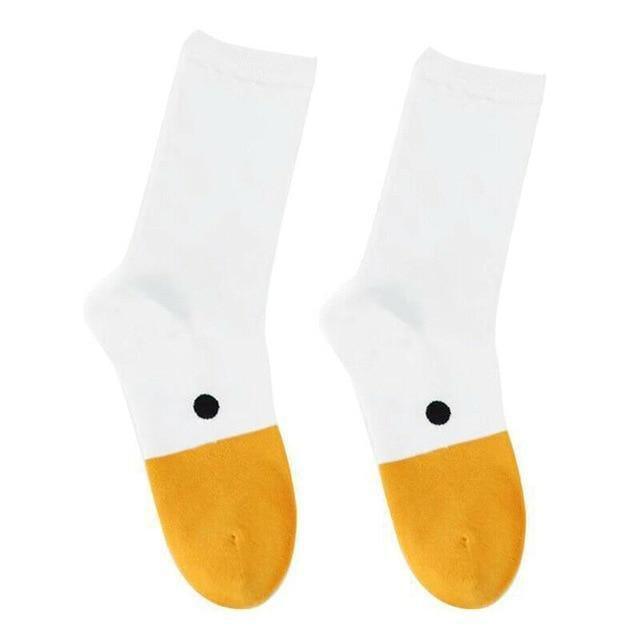 White socks with orange toe and cuff, black dot on ankle