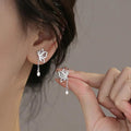 Silver butterfly stud earrings with long dangling chain and teardrop charm