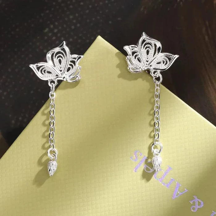 Silver butterfly stud earrings on chain with two teardrop charms