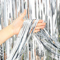 Silver metallic fringe curtain backdrop, shiny strips with hand-held edge