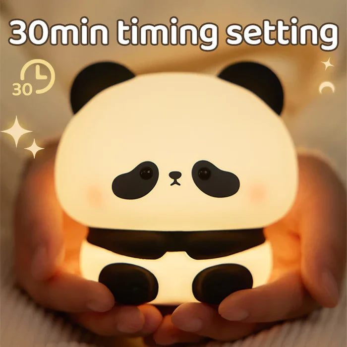 Panda LED night light held in hands, rounded head and warm yellow light